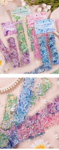 Macro detail of PET floral stickers with laser holographic finish for journaling
