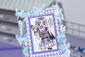 Macro shot of Midsummer Night acrylic kpop photo card holder with purple butterfly stickers