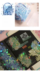 Detailed macro view of holographic flower and moon stickers on black paper background