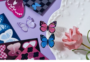 Detailed close-up of glittery butterfly stickers with shimmering laser effect and pastel backgrounds