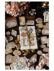 Detailed view of vintage butterfly and floral paper stickers with retro stamps and lace décor
