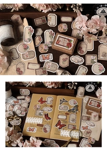Close-up of vintage butterfly and floral stickers for journaling with retro packaging