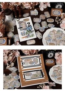 Close-up of vintage butterfly and plant stickers with rustic scrapbooking embellishments
