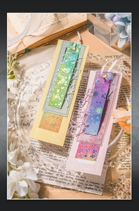 Detailed view of iridescent laser PET bookmark with lace edge and white silk ribbon