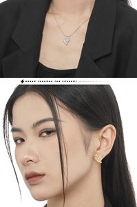 Detail of pink heart-shaped crystal earrings and necklace with textured silver edges