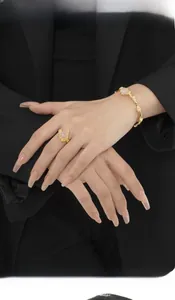 Close-up of gold lava texture ring and bracelet set with translucent pink agates