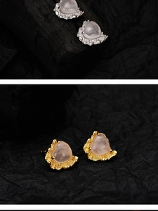Macro detail of heart-shaped pink crystal earrings with artistic lava texture base