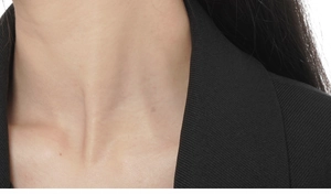 Detail of black rib-knit collar design showing fine woven fabric texture and stitching