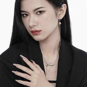 Silver fringe earrings and pearl necklace set shown on a model in a black suit