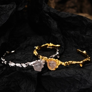 S925 silver and gold bracelets with pink agate stones and lava texture on dark background