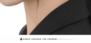 Detail shot of the textured black twill fabric collar and tailoring on a classic suit jacket