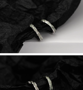 Macro view of mint green enamel textures on irregular silver lava molten ear cuff earrings