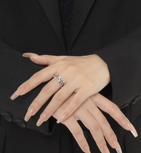Detail of star-patterned silver ring with micro-set zircon on model's hand