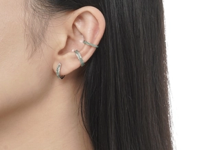 Detailed close-up of mint green S925 silver ear cuffs with hammered metal texture