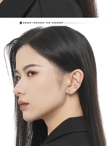 Detail of mint green marble inlay silver ear cuffs and hoop on a female model