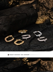 Detailed macro view of luxury geometric earrings with micro-pave cubic zirconia crystals