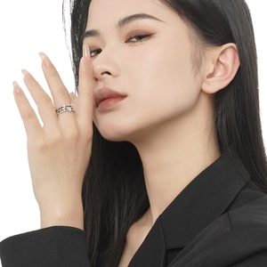 Minimalist S925 sterling silver star ring with zircon inlay worn by model on white background