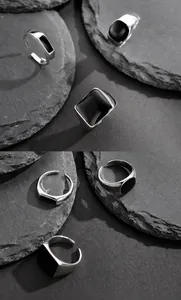 Detail of vintage S925 sterling silver ring with black enamel on stone texture base