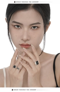 Close-up of retro S925 sterling silver rings with black enamel inlay on a model
