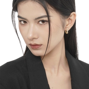 Luxe gold hoop earrings with sparkling cubic zirconia on a model for a chic look