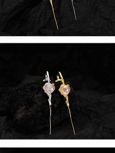 Detail von S925 Silber Herz-Ohrring mit rosa Kristall auf Vintage-Zweig-Struktur