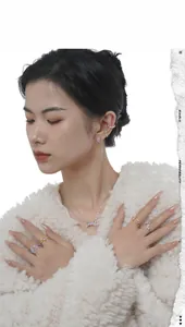 Detail of elegant silver and gold jewelry set featuring pink oval gemstones on a model