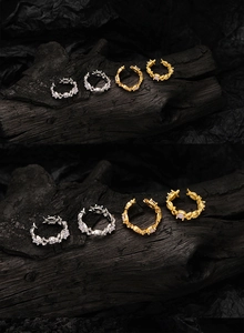 Macro detail of vintage floral relief rings in gold and silver with opal gemstones