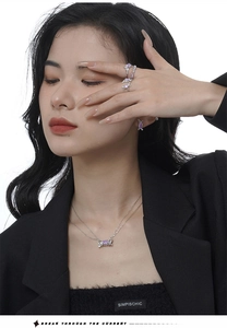 Detail of silver S925 necklace, rings and earrings set with purple zircon gemstones