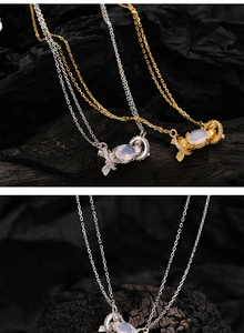 Close-up of candy-shaped S925 silver pendants with oval opal stones and micro-pave zircons