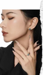 Detail showing S925 sterling silver earrings and ring set with cyan square-cut gemstones