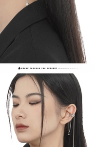 Detail of silver tassel ear cuff featuring hollow chain layers and shell pearl accents