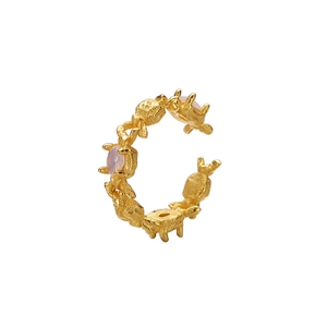 Golden C-shaped ear cuff featuring textured marine style links and three pink gemstones