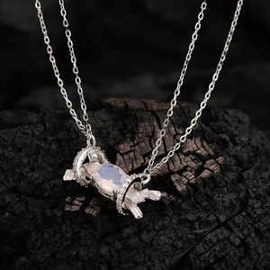 S925 silver necklace with a pink opal pendant in wing design on dark charcoal texture