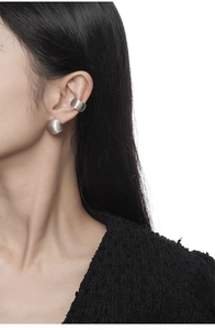 Detailed view of matte brushed S925 silver ear cuff and stud earring on model