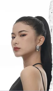 Close-up of model wearing large polished irregular silver S925 sterling silver stud earrings