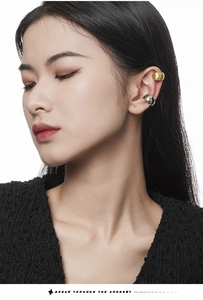 Close-up of minimalist matte gold and polished silver ear cuffs on ear for non-pierced ears