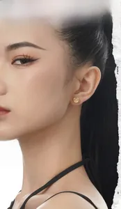 Close-up of a 925 sterling silver earring with white agate on a model's ear lobe