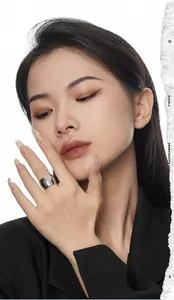 Close-up of wide silver starburst ring on model with artistic paper tear background