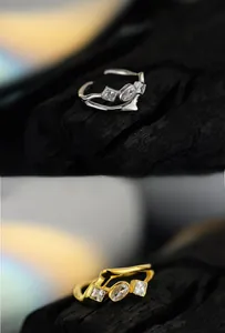 Detail of geometric S925 silver rings with zircon stones in gold and silver finishes