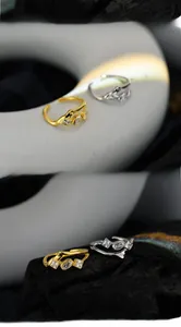Macro shot of lava-textured sterling silver rings with marquise and square zircons