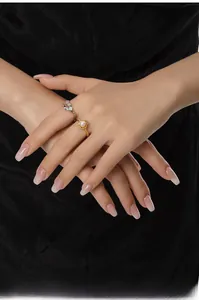 Close-up of pearl and zircon S925 silver rings on model hand with black background