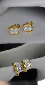 Macro view of two-tone S925 silver earrings with layered frosted and polished textures