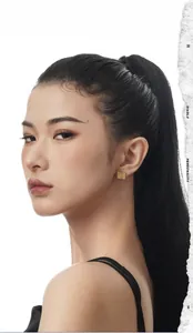 Close-up of model wearing square gold earrings with unique hammered metal texture