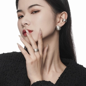 Minimalist matte silver earring and ring set with brushed metal texture on female model