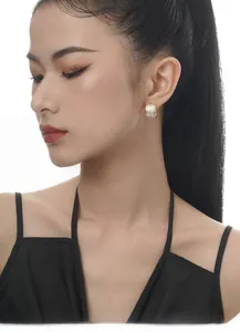 Close-up of elegant wide hoop earrings with three rows of sparkling pave zircons