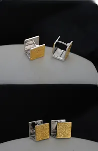 Detailed macro view of S925 sterling silver square earrings with vintage pattern and hallmark