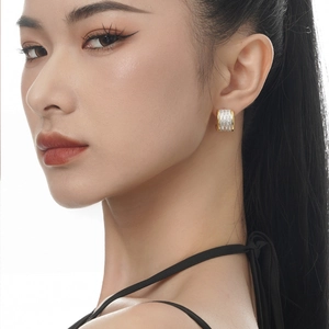Two-tone silver and gold wide hoop earrings with textured finish and luxury design