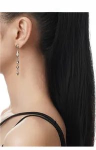 Close-up of S925 silver irregular tassel earrings with baroque pearl on model