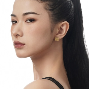 Minimalist square S925 silver earrings with gold textured finish worn by a model