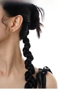 Detailed close-up of a silver star stud earring with a yellow zircon on a model's ear